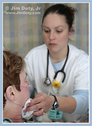 Bille washing a patient's face. Photo copyright Jim doty, Jr.